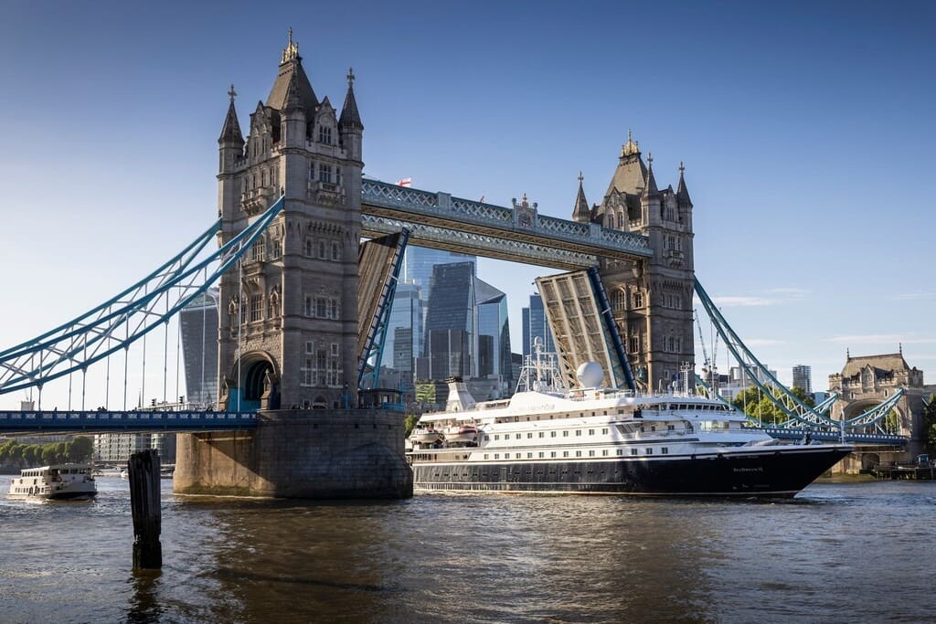 SeaDream Yacht Club’s mega-yacht SeaDream II sailing under the city’s iconic Tower Bridge