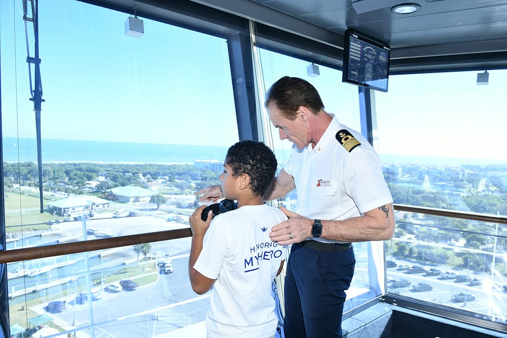 Carnival Cruise Lines' Mardi Gras Captain Alessandro Iemmi with Family of the Fallen on the bridge