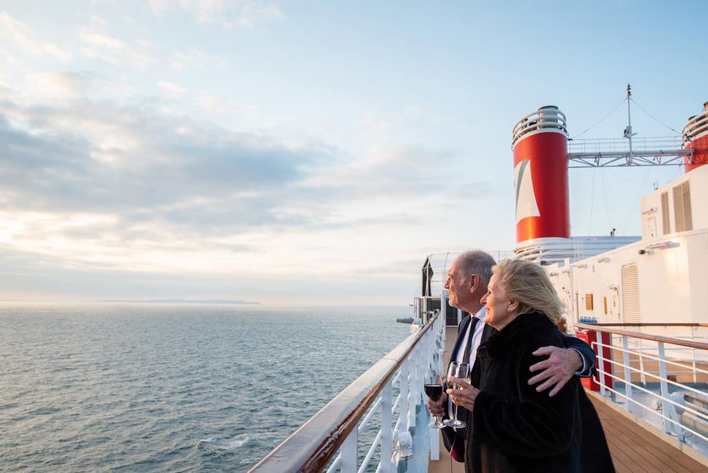 Guests with drinks on deck on Fred. Olsen Cruise Lines Bolette