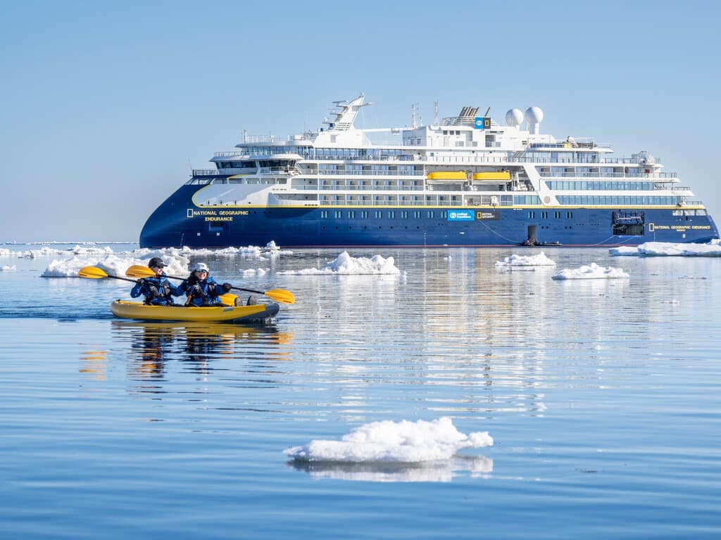 Guests from the National Geographic Endurance kayaking in ice off the island of Edgeoya, Svalbard, Norway.