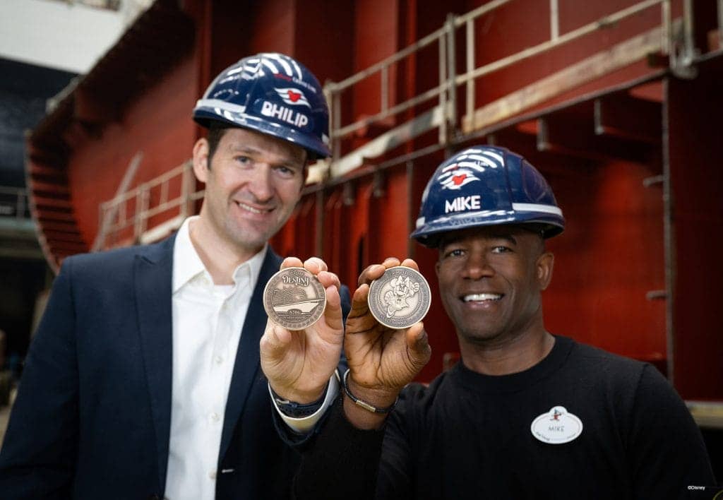 Portfolio Project Management Executive Philip Gennotte and Project Management Executive Mike Davie from Walt Disney Imagineering Germany celebrated the keel laying ceremony for the Disney Destiny in Papenburg, Germany. Keel laying takes place when a newly minted coin is placed under the first block for good fortune.